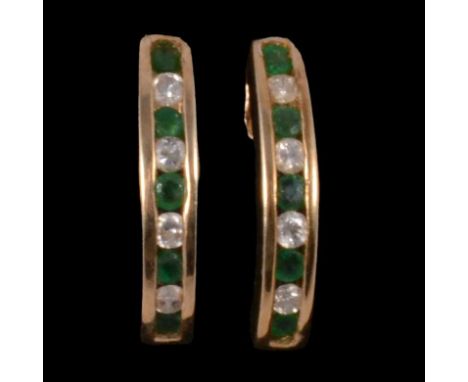 A pair of emerald and diamond half hoop earrings, each earring with five brilliant cut emeralds divided by four brilliant cut