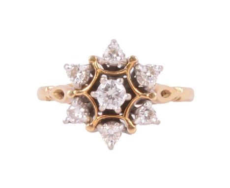 A diamond cluster ring, the central brilliant cut stone, approximately 3.6mm diameter, surrounded by six smaller brilliant cu
