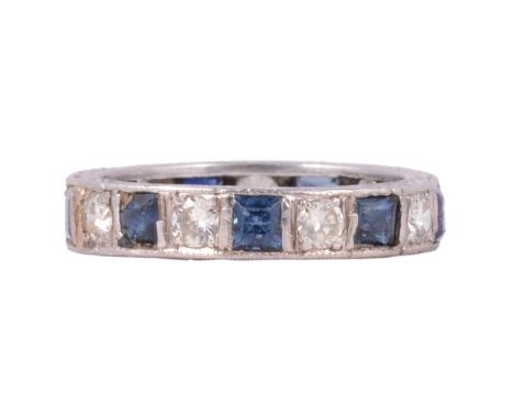A sapphire and diamond full eternity ring, the nine square cut sapphires and nine brilliant cut diamonds claw set in an unmar