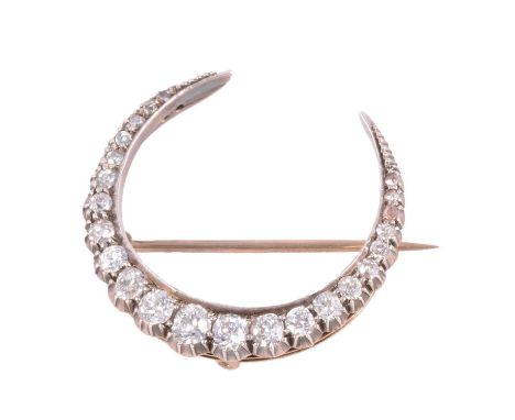 A diamond closed crescent brooch, twenty-three old and rose cut diamonds graduating in size claw set in a 27mm diameter yello