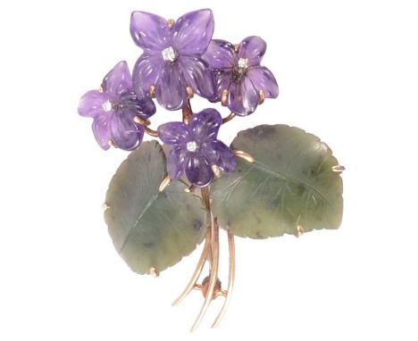 An amethyst and jade floral design brooch, four amethyst violet heads set with a synthetic white stone to centre and two gree