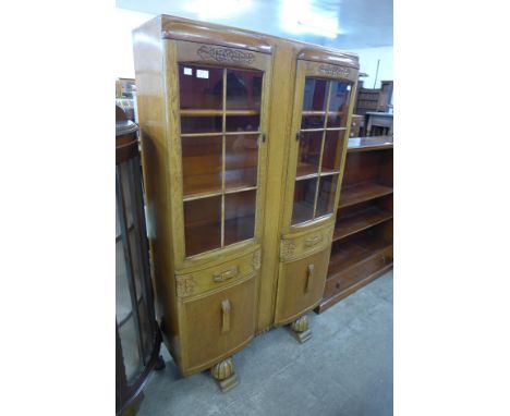 A carved oak four door bookcase 