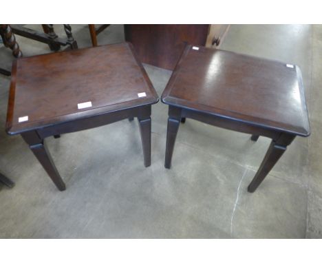 A pair of Stag Minstrel mahogany lamp tables 