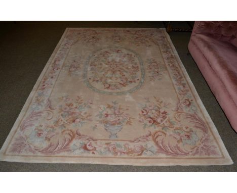 Savonnerie style carpet, China, The camel field with oval central panel enclosed by floral borders, 274cm by 183cm