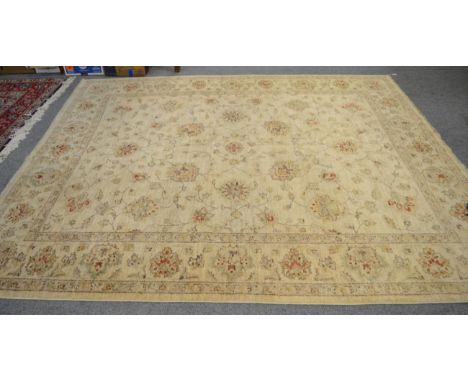 An Afghan 'Ziegler' Carpet of unusual size, the cream field of scrolling vines enclosed by floral borders, 270cm by 230cm