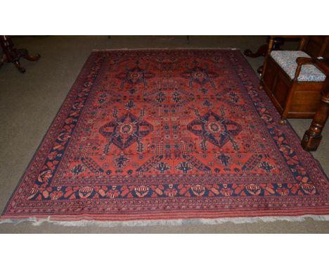 Good Turkmen carpet, North West Afghanistan, modern, the brick red field with four large medallions enclosed by charcoal bord