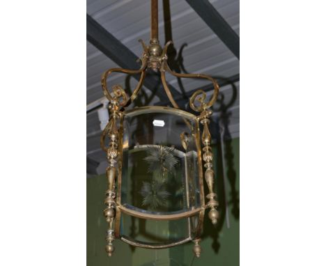 A brass four glass ceiling lantern with scroll arms 
