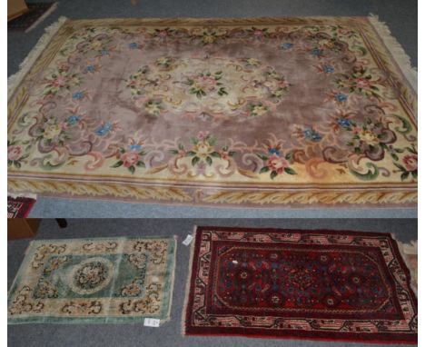 A small Chinese carpet; a Chinese silk rug and two other rugs (4)