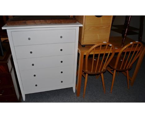 A pair of Ercol stick back chairs; a modern white painted chest of drawers; an oak table and a small oak-finish filing cabine