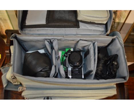 A camera bag containing a Canon camera and accessories