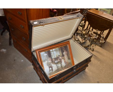 A metal and wooden bound travelling trunk 