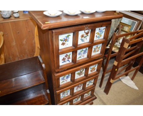 A Continental pine and tile chest, fitted three drawers with drop front