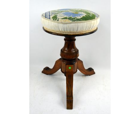 Mahogany framed piano stool with tapestry seat on tripod base.