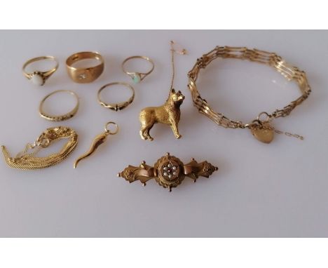 A Victorian Etruscan-style gold memorial brooch with seed pearl and ruby decoration; a gate-link bracelet with lock clasp, 17