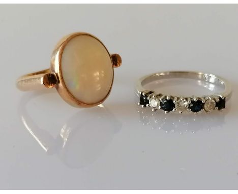 A sapphire and diamond seven-stone ring on white metal, signed GRAFF, 2.6g and an oval cabochon opal ring on a yellow gold se