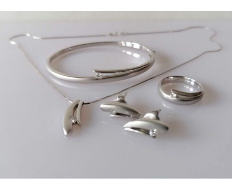 An Italian white gold parure comprising pendant chain, hinged bangle (60mm), ring (size N) and earrings, each with diamond de
