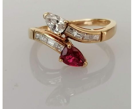 An Italian diamond and ruby crossover ring on a yellow gold setting, the marquise-cut diamond, 5.5 x 4mm and ruby 6 x 5mm bot