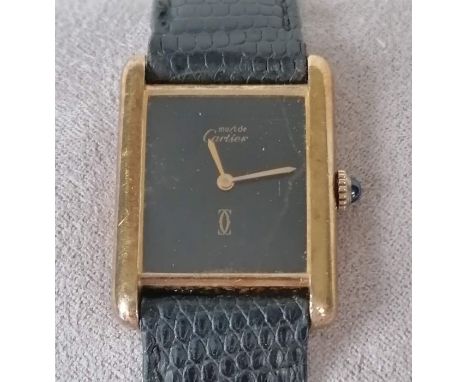 A gold plated Must de Cartier manual wind wristwatch Cartier, the rectangular black dial signed, gilt hands, polished gold pl