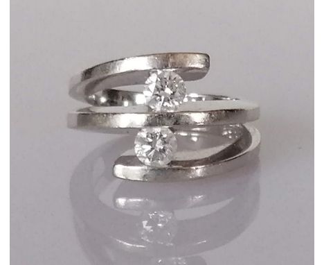 A two-stone diamond ring, each round brilliant-cut diamond weighing an estimated 0.32 carats, assessed colour and clarity F-G