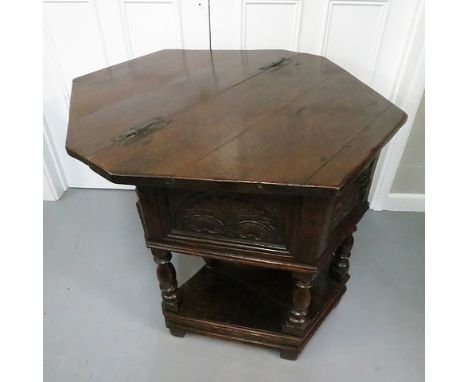 A small and rare oak credence table of triangular form, the hinged top supported by a single gate with turned balusters, the 