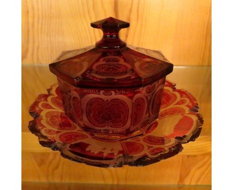 A 19th century Bohemian ruby flashed cut and engraved dish and cover on a stand, decorated with scenes of Spa building, 5 dia