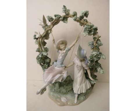 A Lladro figurine depicting girls on a swing, 18 high