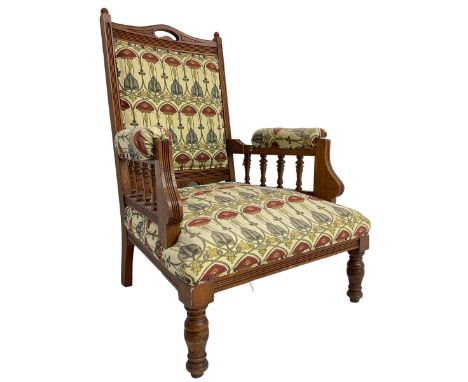 Early 20th century armchair, back and sprung seat upholstered in Art Nouveau patterned fabric, raised on ring turned supports