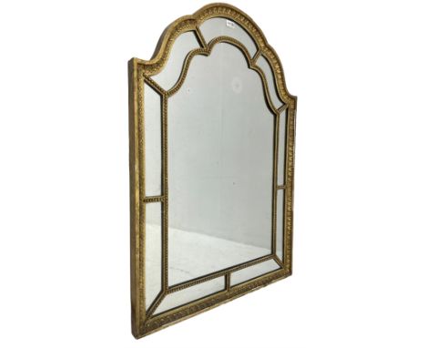 19th century arch top giltwood and gesso framed wall mirror, foliate decorated edge with beaded astragal design barsDimension