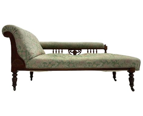 Late Victorian walnut framed chaise longue, scrolled back, the arm with turned balustrade supports, sprung back and seat upho