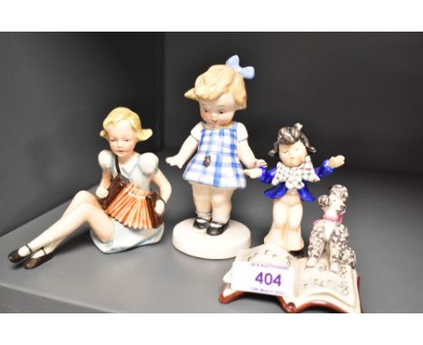 Three Goebel figurines having early bee stamps including Child and Poodle Reading, Girl Playing Accordian and Girl with Ladyb