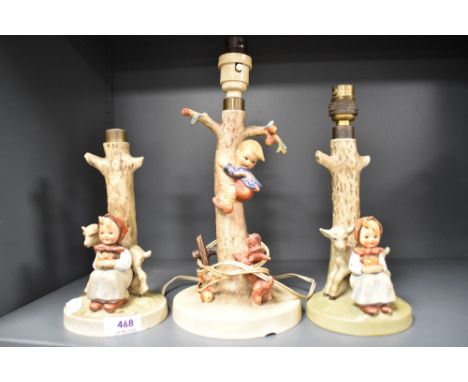 Three Goebel Hummel figural lamp bases including two of Girl with Goat and One of Boy up a Tree.