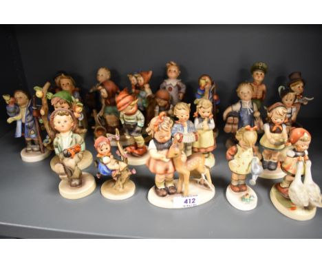 Twenty Two Goebel Hummel figures in varying poses and subjects, all in good condition.
