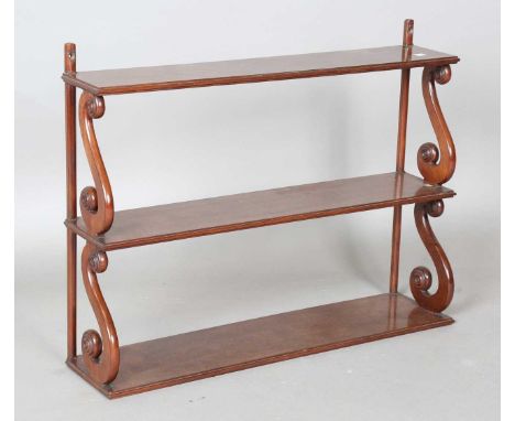 A Regency mahogany three-tier hanging wall shelf on 'S' scroll supports, height 55cm, width 71cm, depth 17cm.