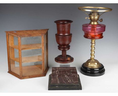 An early 20th century turned hardwood goblet, height 29cm, a 19th century rouge marble display plinth, width 21cm, a Victoria