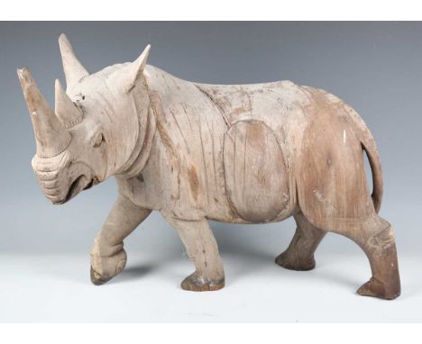 A large 20th century carved hardwood model of a rhinoceros, length 60cm.