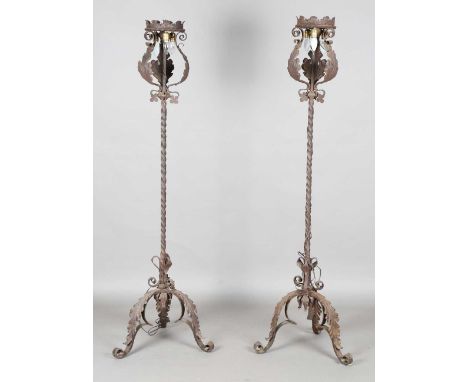 A pair of 20th century Continental wrought iron lamp standards with spiral twisted stems and acanthus leaf mounts, height 184
