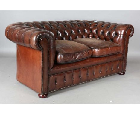 A 20th century buttoned brown leather Chesterfield settee, height 76cm, width 176cm, depth 95cm.