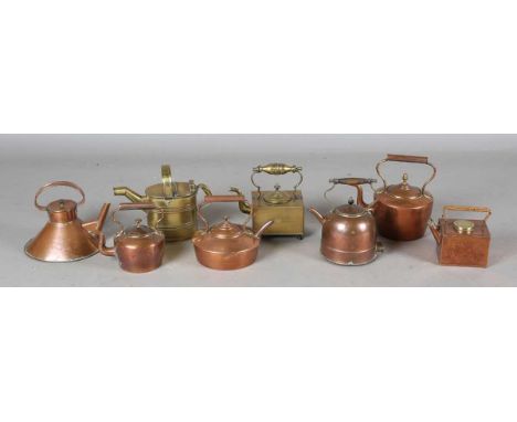 An Edwardian brass watering can by Army &amp; Navy, together with a group of mainly Victorian copper kettles.