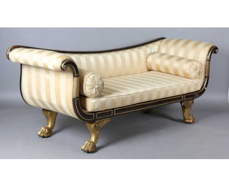 A Regency simulated rosewood and parcel gilt settee, in the manner of Gillows of Lancaster, upholstered in striped yellow sil