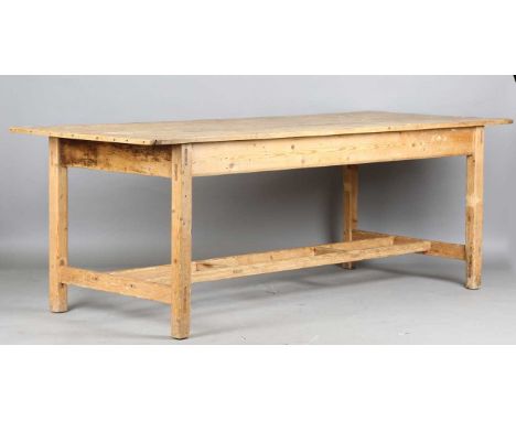 A late 19th/early 20th century pine rectangular kitchen table, the block legs united by a ladder style stretcher, height 79.5