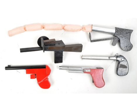 Magic Tricks - a collection of x5 Magicians wooden novelty firing pistol / guns to include a sausage firing spring loaded gun