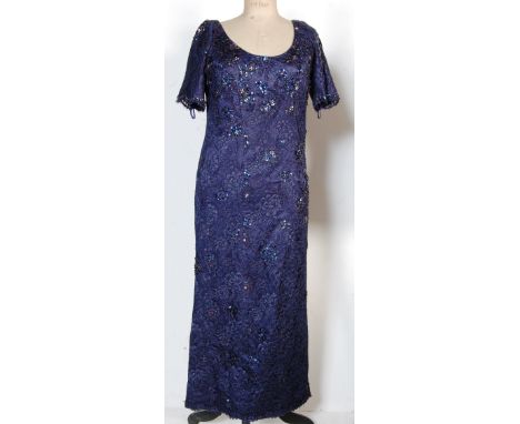 From the collection of Valerie Leon - a personally owned and worn evening gown. The navy blue couture dress by designer Tomas