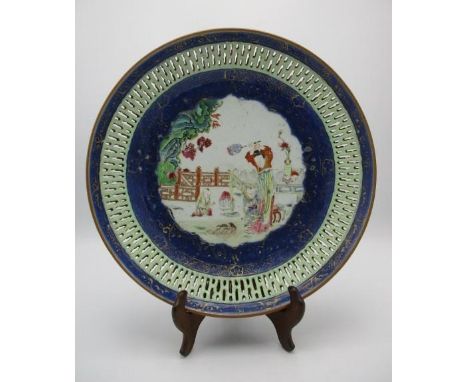 A large 18th century Chinese dish with a pierced band, designed with a powder blue rim with gilt embellishment, the centre de