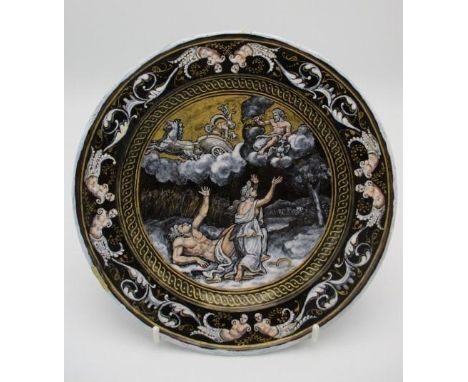 An 18th/19th century French enamel plate decorated to the centre with an allegorical scene and nude figures to the border, a 