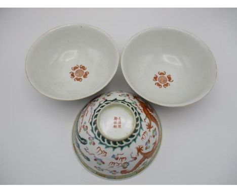 Three early 20th century Chinese bowls decorated with a phoenix, a dragon and clouds, in polychrome enamels, 3" h, 7 1/4"diaC