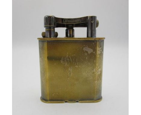 An early 20th century silver plated Dunhill table lighter with engine turned decoration, patent no 390107, reg design no 7374