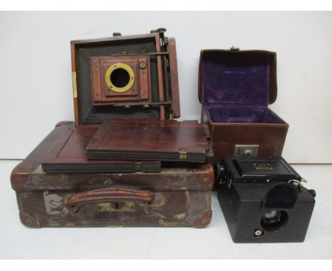 An Ensign Focal Plane Roll Film Reflex camera in a brown leather carrying case and a J Lancaster &amp; Son mahogany cased pla