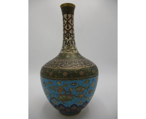 A late 19th/early 20th century Chinese cloisonne vase of baluster form with a tall narrow neck, decorated with swags, flowers