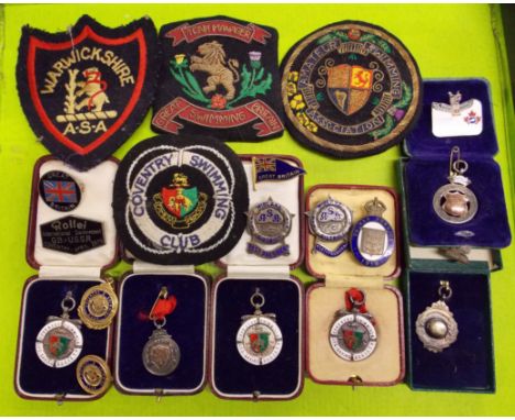 SELECTION OF CASED SILVER AND ENAMEL COVENTRY SWIMMING MEDALLIONS, INTERNATIONAL SWIM  - MEET BADGES AND SEW ON BADGES