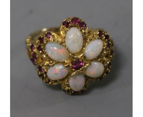 A 1970's 9ct gold, white opal and ruby cluster dress ring, size M.